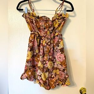 Forever 21 floral shorts romper with ruffled hem and pockets. Size medium